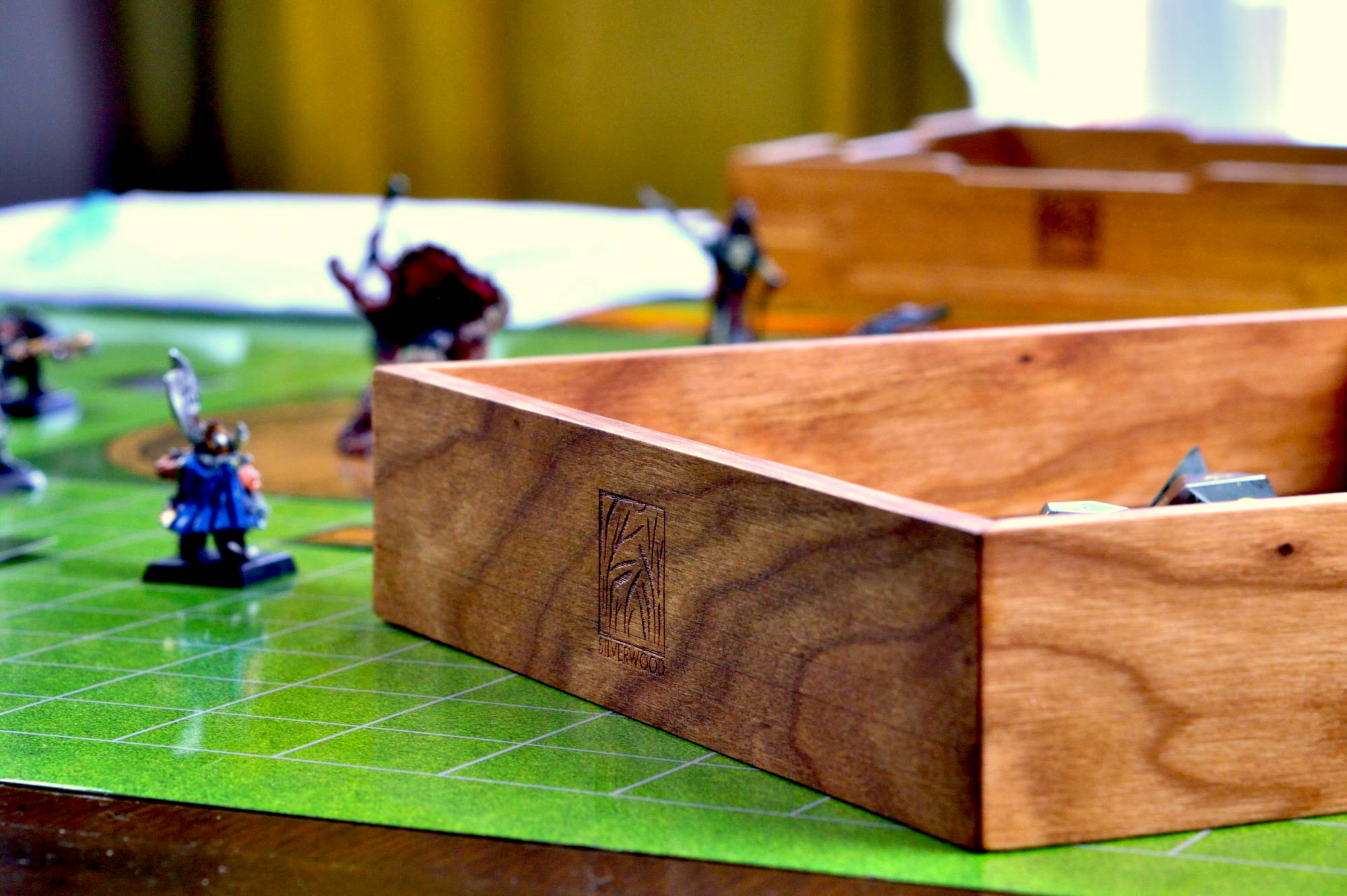 Cherry Artisan Dice tray on a game table with miniatures in the background